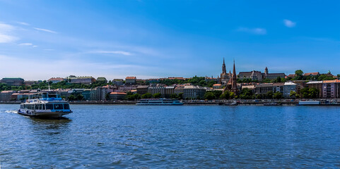 River ferry on the Danube in Budapest with the Castle District in the background during summertime