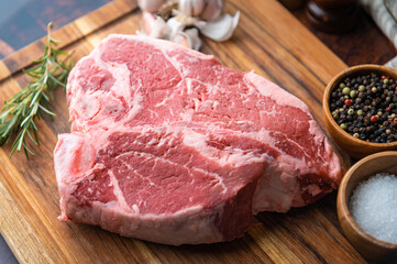 fresh thick cut  T-bone steak on wooden cutting board
