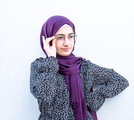 Arabic muslim girl holding her glasses on her face