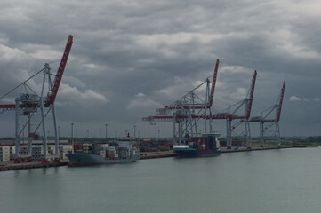 View at Dunkirk from the Canal between England and France on industry, cranks, container ships and port of Dunkirk in France