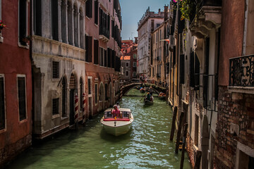 Fototapeta na wymiar Amazing view on the beautiful Venice, Italy. Many gondolas sailing down one of the canals.