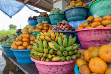 A roadside market stall sits on the side of a road in the rural village of Penestanan near Ubud, Bali, Indonesia.