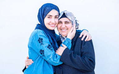 Arabic muslim daughter hugging her mother