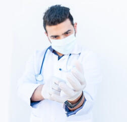 Arabic doctor wearing gloves to protect him self from infection