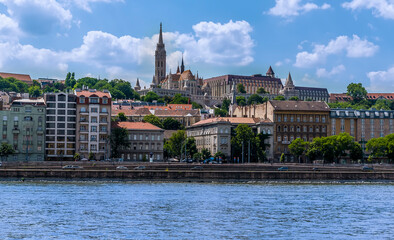 A view of the west bank of the River Danube in Budapest towards the Fisherman's Bastion from a boat on the river during summertime