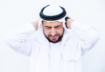 Arabic man covering his ears from loud noise