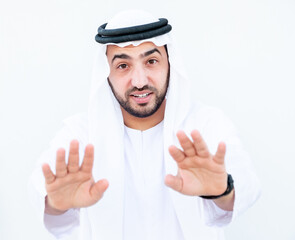 Arabic guy raising his hands to stop something