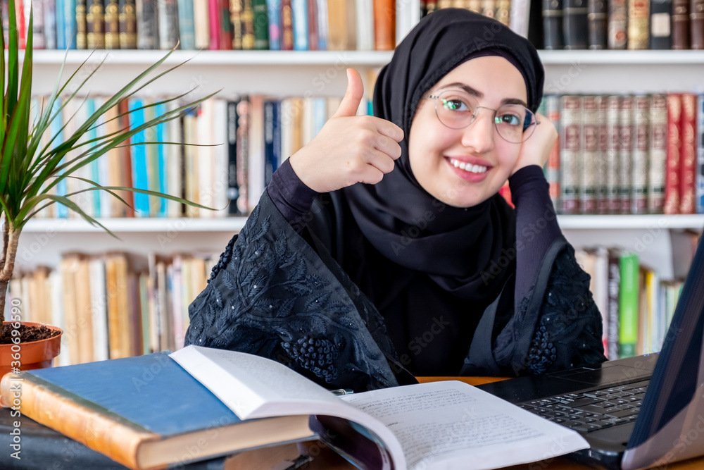 Wall mural happy arabic muslim woman after finishing study