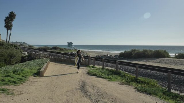 Woman happy Beautiful sunny summer Day Walking at ocean coast close to rails. Travel Vacation Retirement Lifestyle Concept California Orange county San clemente