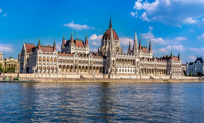 Fototapeta na wymiar A view of the Parliament building on the eastern shore of the River Danube in the summertime