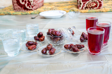 Arabic sit with date and water and juice preparing for iftar