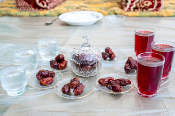 Arabic sit with date and water and juice preparing for iftar