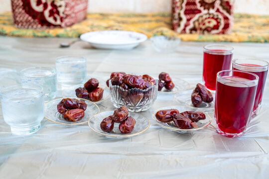 Arabic sit with date and water and juice preparing for iftar