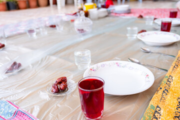 Arabic sit with date and water and juice preparing for iftar