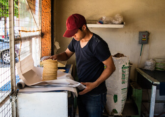 young man selling tortillas of nixtamal