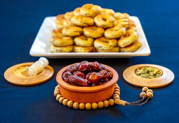 Eid sweets in a white bowl wiht some date