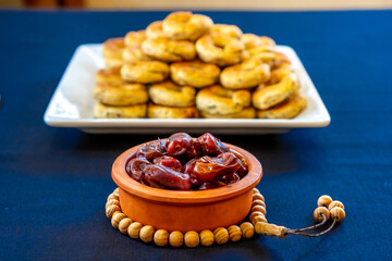 Eid sweets in a white bowl wiht some date