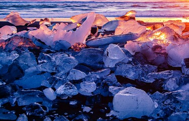Focus on icebergs laying on the black sandy beach in Iceland 