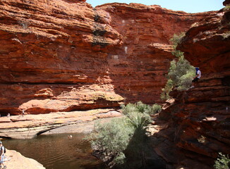 Tourists sitting and swimming at Garden of Eden Waterhole in Kings Canyon outback central Australia
