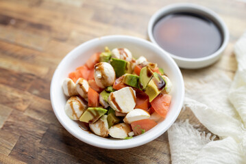 Home made avocado and tomato salad with fresh mozzarella and balsamic glaze  