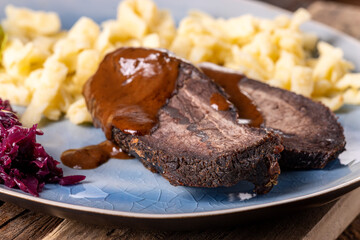 closeup of a german sauerbraten with dumplings