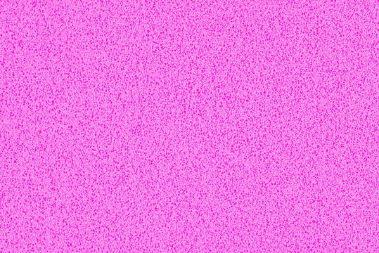 A macro photo of a pink gradient color with texture from real foam sponge paper for background, backdrop or design.