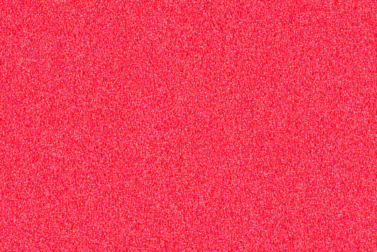 A macro photo of a red gradient color with texture from real foam sponge paper for background, backdrop or design.
