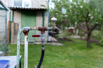 Old rusty water tap in the country