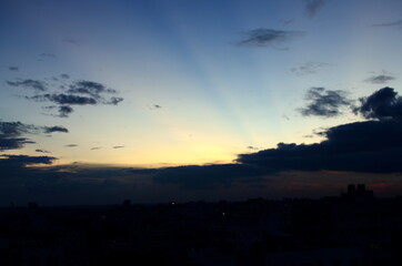 Fototapeta premium Sunset sky. Beautiful evening view of the cloudy sky over the Savar City, Bangladesh. Amazing colours in the sky as the sun falls behind the horizon.