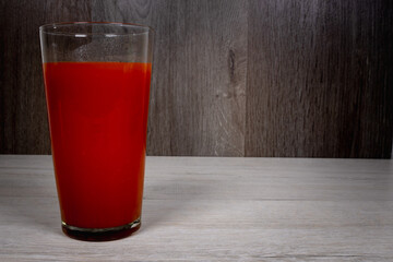 Freshly made tomato juice in a tall glass.