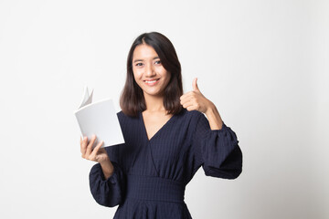 Young Asian woman thumbs up with a book.