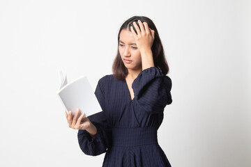 Young Asian woman got headache read a book.