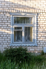 Fototapeta na wymiar Window in the cottage. Window in a rural house.
