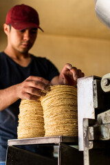 young man selling tortillas of nixtamal