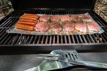 Meat cooking a backyard charcoal grill