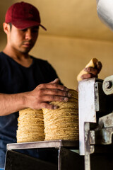young man selling tortillas of nixtamal