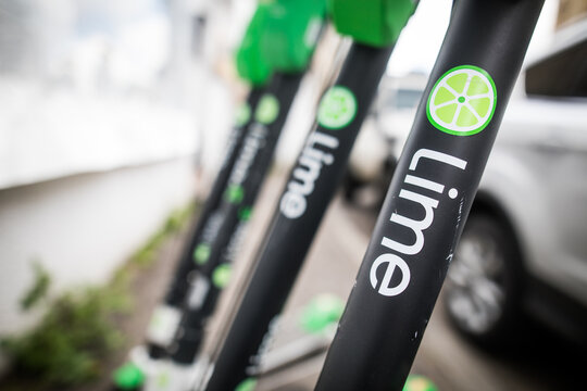 Lime-s e-scooters parked on sidewalk