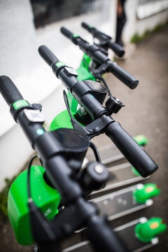 Lime-s e-scooters parked on sidewalk