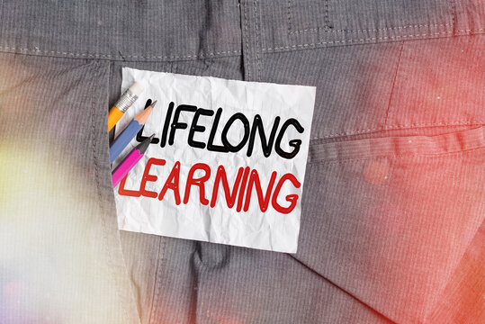 Text sign showing Lifelong Learning. Business photo showcasing pursuit of knowledge for an individualal or professional reasons Writing equipment and white note paper inside pocket of man work