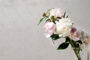 Beautiful bouquet of peonies in a glass vase