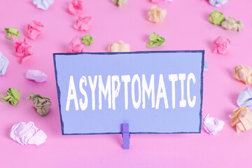 Writing note showing Asymptomatic. Business concept for a condition or an individual producing or...