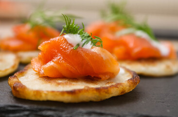 Salted salmon with dill on a pancake.