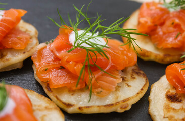 Salted salmon with dill on a pancake.