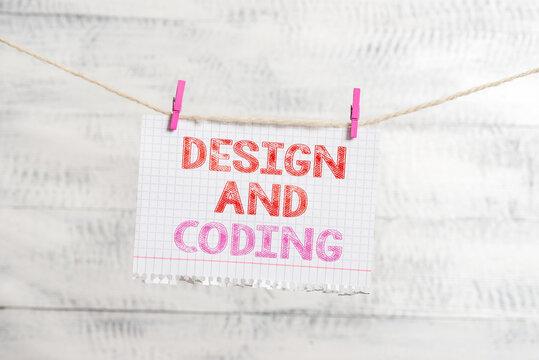 Writing note showing Design And Coding. Business concept for HTML and programming, Cross platform development website Clothesline clothespin rectangle shaped paper reminder white wood desk