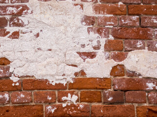 Old brick wall weathered and broken bricks, background.Texture. Close up.