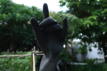 Black gardening gloves plugged onto the bamboo stick and show as a sign of love.