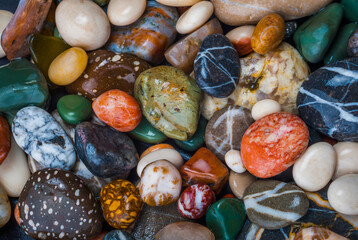 Background of wet colored pebbles close-up