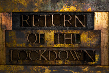 Return of the Lockdown text formed with real authentic typeset letters on vintage textured silver grunge copper and gold background