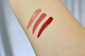 Three shades of liquid lipstick on a female arm