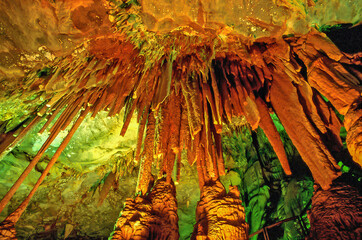 Stalactites and stalagmites inside of the Rei do Mato Grotto in Minas Gerais State. A stalactite is a type of formation that hangs from the ceiling of caves, hot springs, or manmade structures.